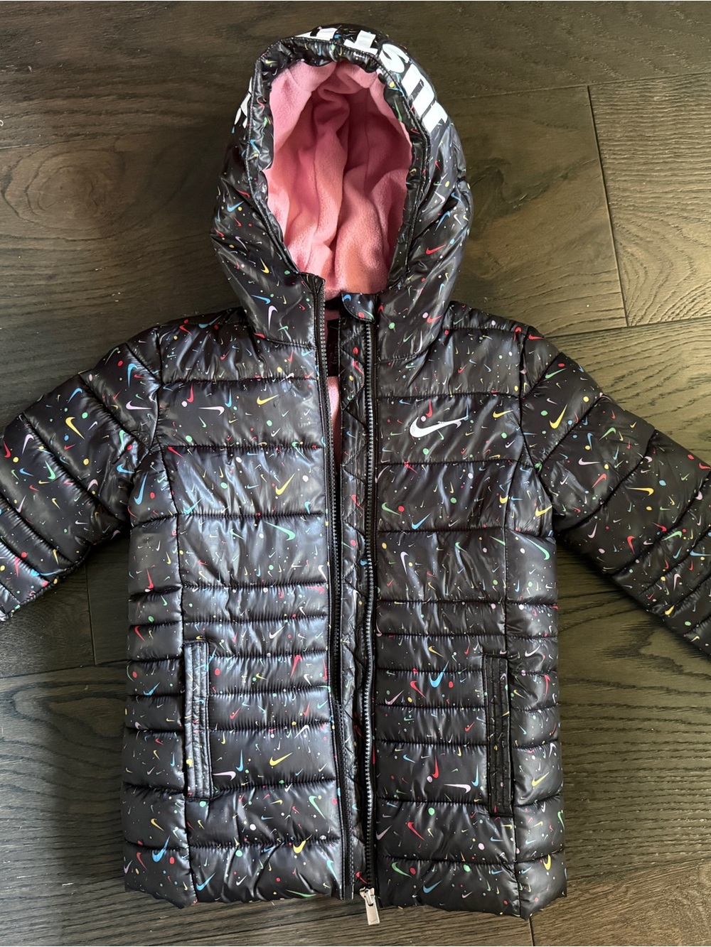 Nike Kids Black Puffer Jacket with Pink Hood Lining and Multicolor Swoosh Print